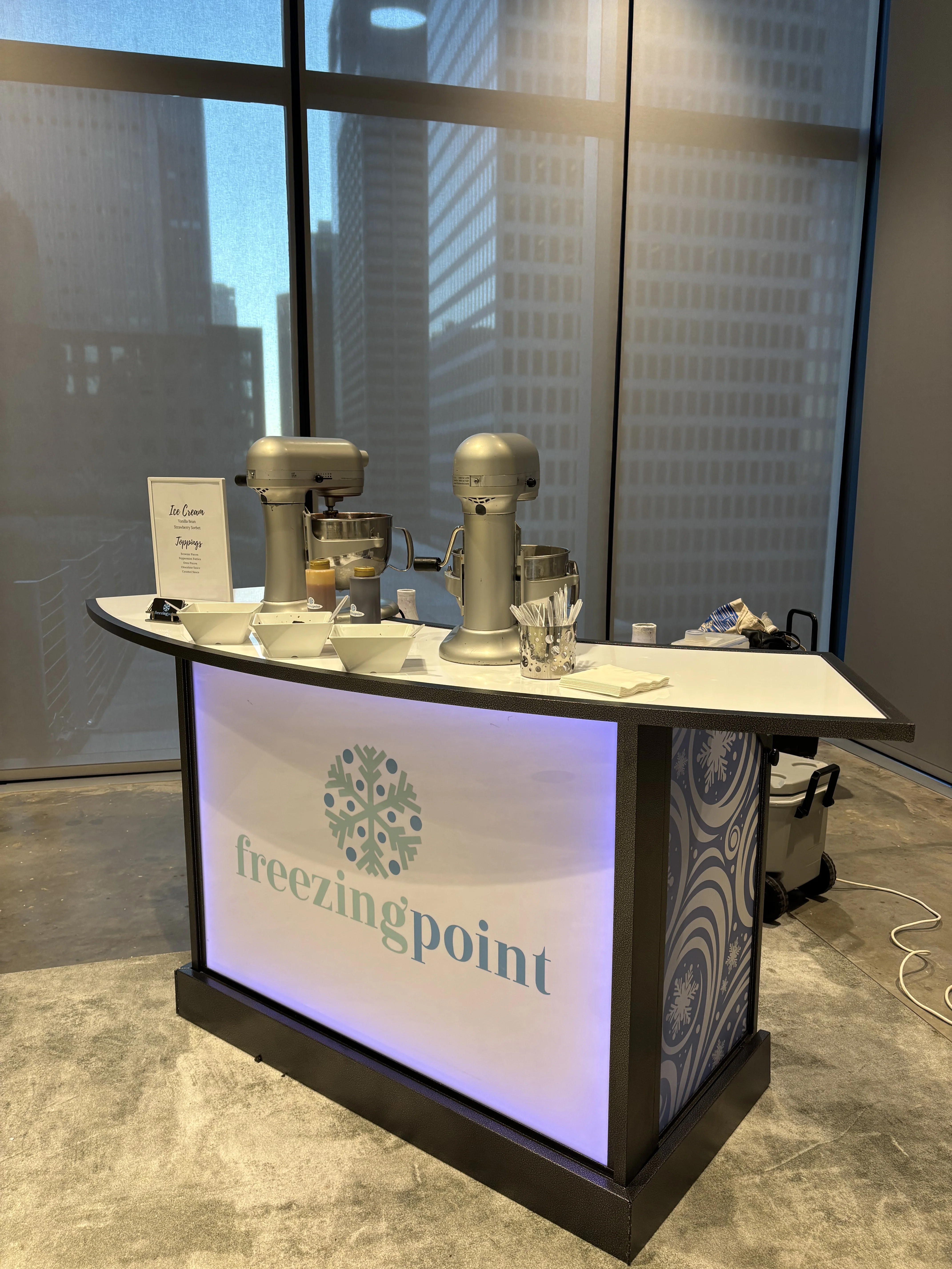Tenant appreciation event ice cream catering: Freezing Point nitrogen ice cream bar with mixers, toppings and a menu set up in a Houston office building